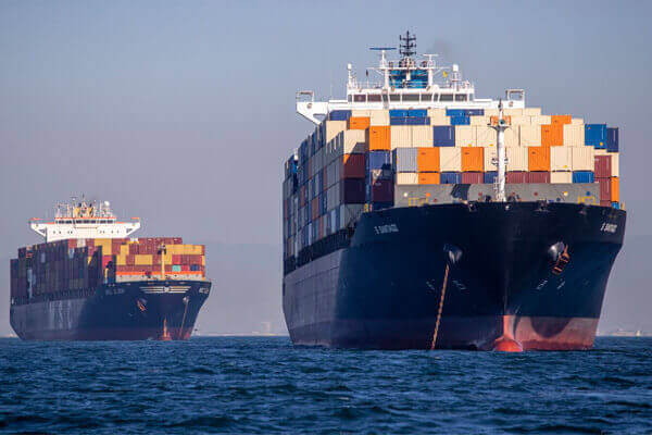 Our Services include two container ships anchored, Ocean Freight Forwarder