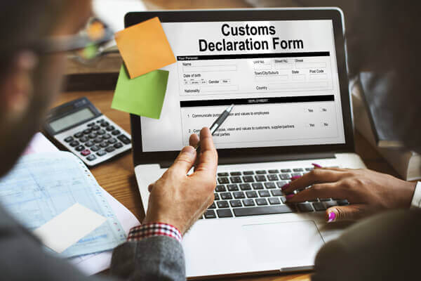Our Services customs declaration forms, on lap top