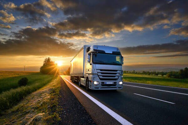 Articulated lorry at dusk lovely backdrop of sunset Our Services Include ROAD Freight Forwarder