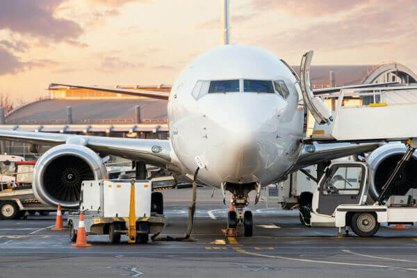 front view of aircraft being loaded with cargo at sunrise Our Services include AIR Freight Forwarding