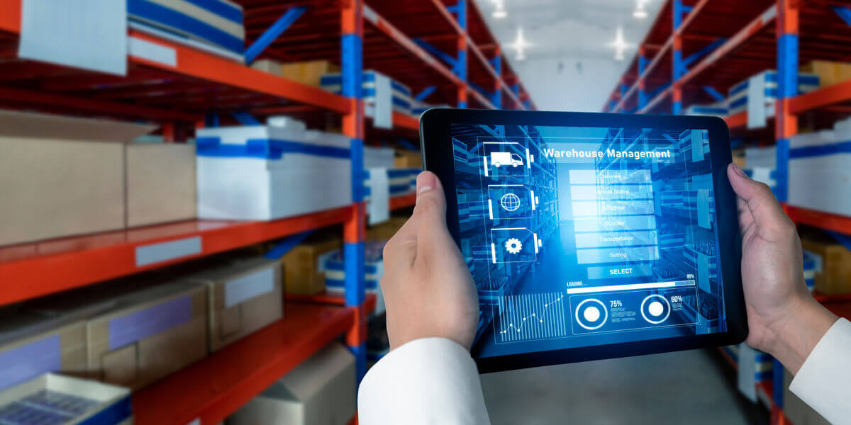 warehousing management system Colchester Essex held on iPad by man in warehouse at SARR Logistics UK