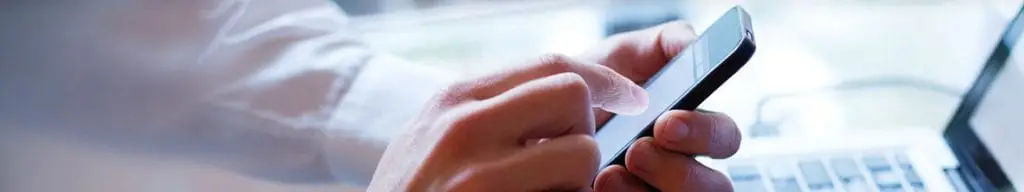 mans hands using mobile phone Contact US